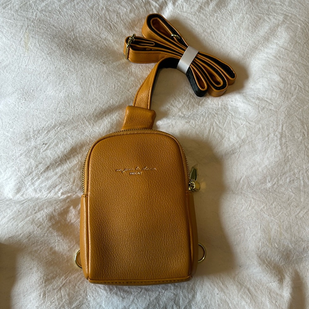 Small sling bag, 2 pockets with cardholders. Brand new!
